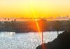 Rays of Light Shining Through A sun set with a ray of light effect overlooking a bay.