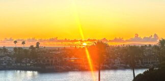 Rays of Light Shining Through A sun set with a ray of light effect overlooking a bay.
