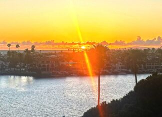 Rays of Light Shining Through A sun set with a ray of light effect overlooking a bay.