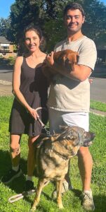 Cooper and Kayley Brunner pose with their dachshund, Gus and German Shepard, Greta. 