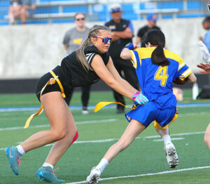 Tualatin's Kenely Anderson rips the flag off an offensive player in the Timberwolves win at Barlow.