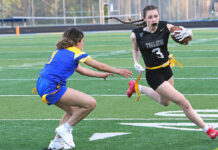 Flag football continues to grow at Tualatin and around the state Tualatin's Paige Estes races around the corner trying to out-run a defender.