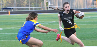 Flag football continues to grow at Tualatin and around the state Tualatin's Paige Estes races around the corner trying to out-run a defender.