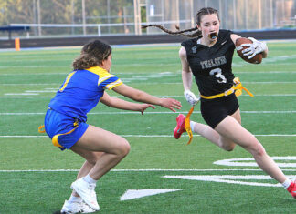 Flag football continues to grow at Tualatin and around the state Tualatin's Paige Estes races around the corner trying to out-run a defender.