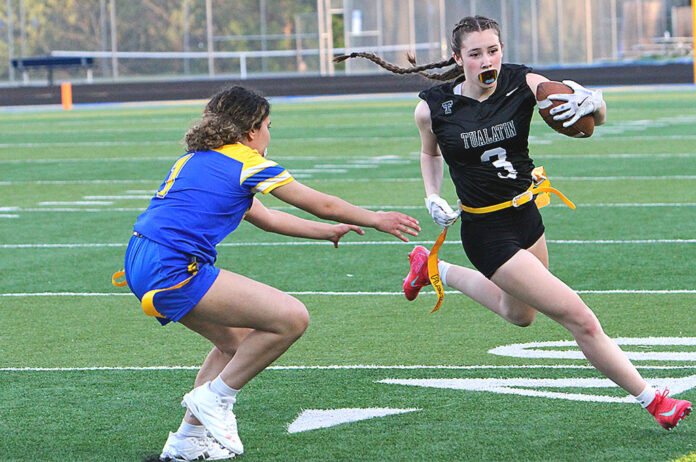 Tualatin's Paige Estes races around the corner trying to out-run a defender.
