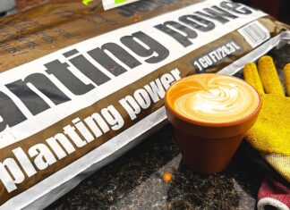Warning: It Was a Circus Here Today A bag of planting power soil on a counter next to a latte in a clay pot mug and gardening gloves.