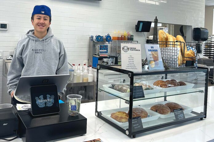 Baguette Bros owner Austin Chen stands behind the register on May 20, 2026. Chen said that the bakery has already established a healthy batch of regulars.