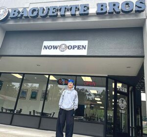 Baguette Bros owner, Austin Chen standing outside his new bakery on May 20, 2026. 