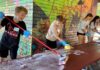 Hazelbrook Middle School Students Spread Kindness Through Day of Service Students washing picnic tables at Community Park shelter.