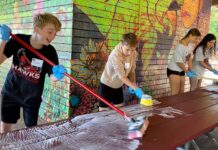Hazelbrook Middle School Students Spread Kindness Through Day of Service Students washing picnic tables at Community Park shelter.