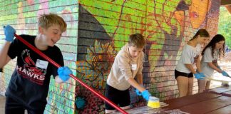 Hazelbrook Middle School Students Spread Kindness Through Day of Service Students washing picnic tables at Community Park shelter.