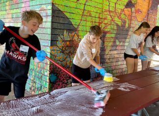 Hazelbrook Middle School Students Spread Kindness Through Day of Service Students washing picnic tables at Community Park shelter.