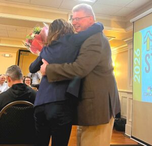 Tualatin City Manager Sherilyn Lombos receives a hug from Mayor Frank Bubenik during his farewell speech on May 19 at the Tualatin State of the City event. 