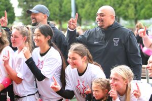 Bubba Lemon and the Tualatin girls flag football team celebrate after winning the state title this spring.