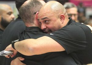 Bubba Lemon hugs an assistant coach after the boys basketball team won the state title this past winter.
