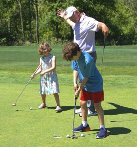 Chad Fribley plays around with his kids, Violet Fribley, 6, and Greyson Fribley, 10, on the putting greens at Persimmon Country Club in Greshman while practicing before heading off to Ohio for the Senior U.S. Open.