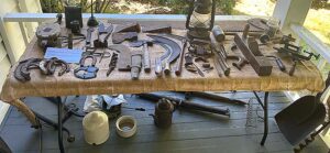 Rusty horseshoes, old tools and other relics recovered on the property were put out on display during the Sweek House tour on July 12, 2026.