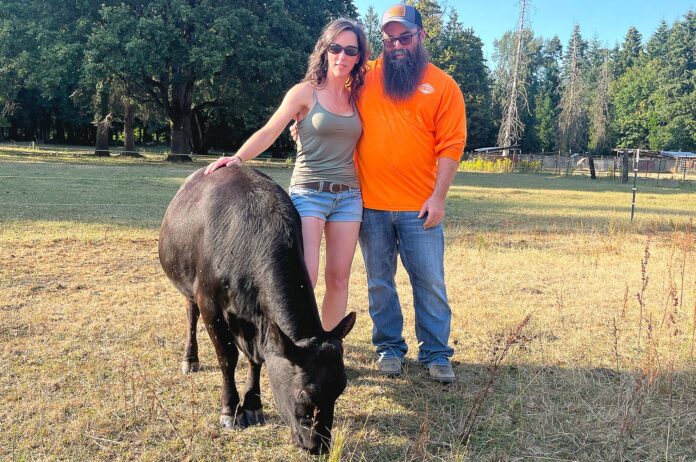 Jensen Mini Farm owners, Jeff and Lory Jensen, posed with their cow Vader on July 15, less than a month after a lightning strike killed ten of their cows.