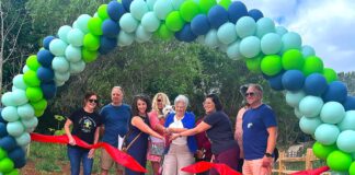 Ribbon Cutting Ceremony at Tualatin’s New Nyberg Creek Trail Tualatin City Councilor Valerie Pratt, surrounded by other key project planners like Tualatin East CIO President Doug Ulmer, cuts the ribbon at the Nyberg Creek Trail grand opening on Saturday, June 20.