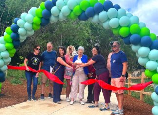 Ribbon Cutting Ceremony at Tualatin’s New Nyberg Creek Trail Tualatin City Councilor Valerie Pratt, surrounded by other key project planners like Tualatin East CIO President Doug Ulmer, cuts the ribbon at the Nyberg Creek Trail grand opening on Saturday, June 20.