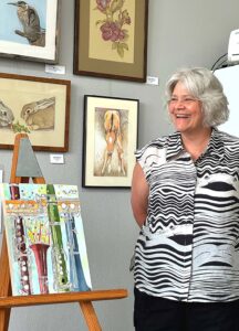 WOW! Secretary Terry Schmidt explains her musical painting at last year's reception. 