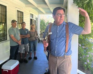 Ross Baker from the Tualatin Historical Society met tourists on the porch of the Sweek House and introduced them to the historic property on July 12, 2026. 
