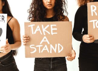 Why not be an Advocate for your own city? Women holding Take A Stand Signs