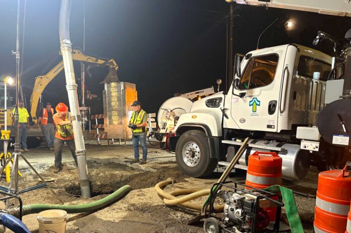 water-leak-1 Tualatin's Public Works Department springs onto the scene after receiving news that the city's transmission line had started leaking under 72nd Avenue in Tigard.