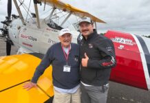 Tualatin Vets Fly Over Aurora in Vintage WWII Planes Bill Manderfeld and pilot Marcus Smith stand in front of a WWII-era plane that flew local veterans out of Aurora State Airport.