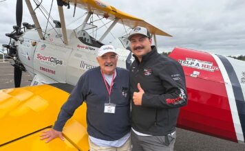 Tualatin Vets Fly Over Aurora in Vintage WWII Planes Bill Manderfeld and pilot Marcus Smith stand in front of a WWII-era plane that flew local veterans out of Aurora State Airport.