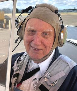 Navy veteran Dale Potts sits in the open cockpit of "Spirit of '45," a restored Boeing Stearman biplane, ahead of his flight with Dream Flights.