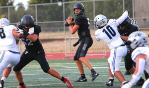 Junior Lincoln Keeney looks to pass in Tualatin's 51-13 win against Mountainside in the season opener.