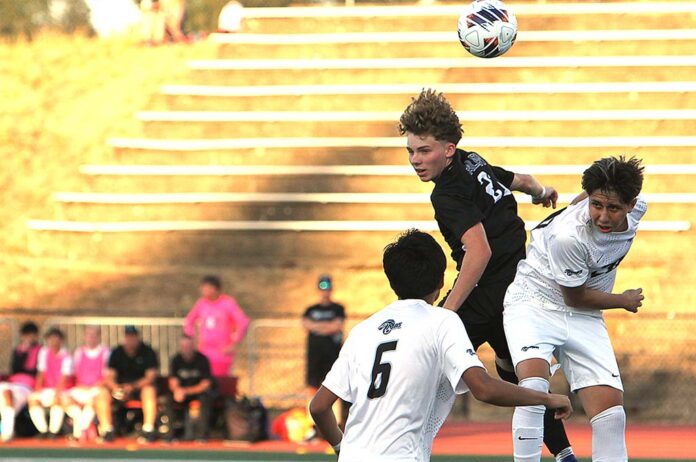 Rowan Hampson leaps for a header in Tualatin’s scoreless tie against Mountainside to open the season.