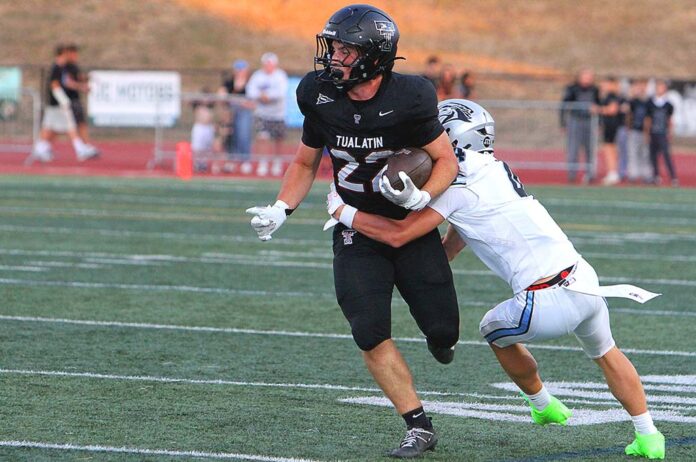 Tualatin-junior-Iden-Rule-helepd-the-Timberwolves-offense-get-going-after-a-slow-start-en-route-to-a-52-13-win-to-kick-off-the-season. Tualatin junior Iden Rule helepd the Timberwolves offense get going after a slow start en route to a 52-13 win to kick off the season.