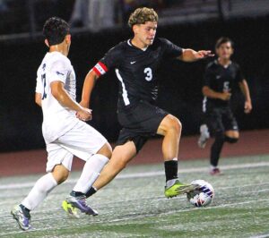 Tualatin senior Julian Rios dribbles with the ball in the Timberwolves first game of the season, a 0-0 tie against Mountainside. 