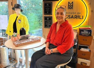 Tualatin Fashion Designer Weaves Stories into Her Work Magsarili sits in front of her neon House of Magsarili sign at her home/office space.