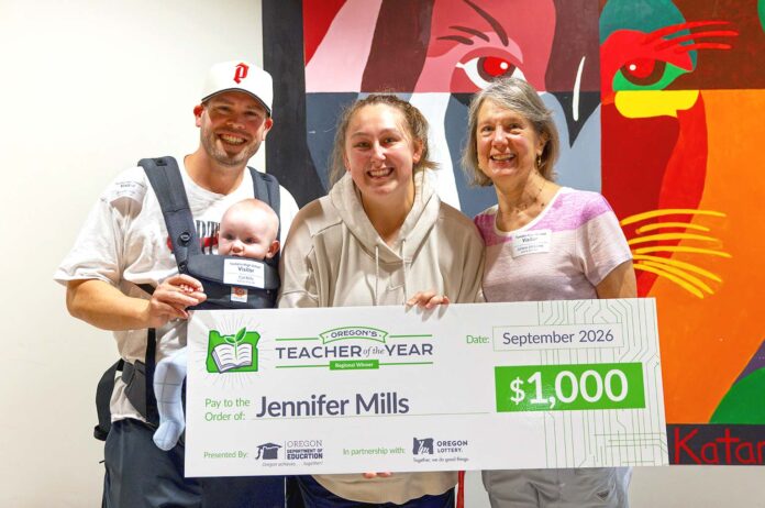 Regional Teacher of the Year Jennifer Mills (center) celebrates her $1,000 prize alongside her husband, Garrett, and son, Cal (left), and her mom, Juliann Williams, (right). Mills, an educator at Tualatin High School, advances to compete for the Oregon Teacher of the Year honor later this fall.
