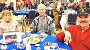 People at a table at the veterans breakfast.