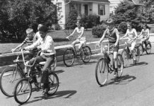 The Kids These Days A black and white photo of kids riding bikes.
