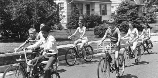 The Kids These Days A black and white photo of kids riding bikes.