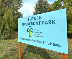 A sign at the proposed site of the Riverfront Park project informs residents as to where the six acres of river access will be developed.