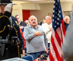 People saluting the flag at the veterans breakfast.